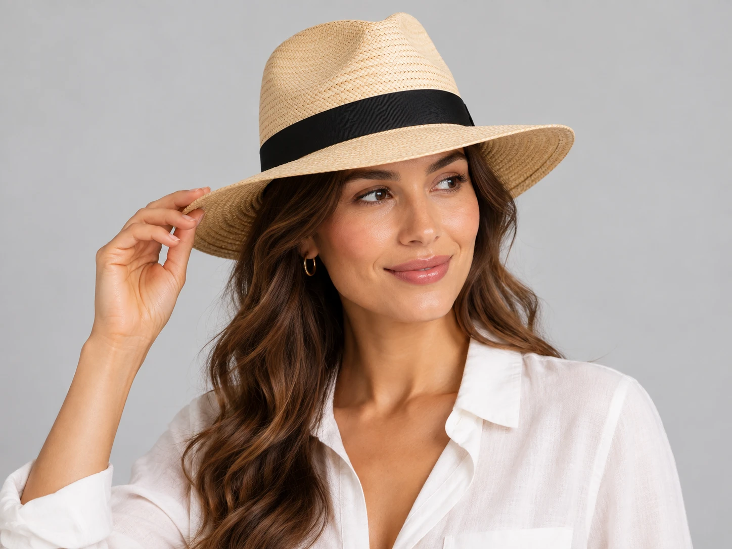 Natural straw panama hat photographed against a neutral studio backdrop